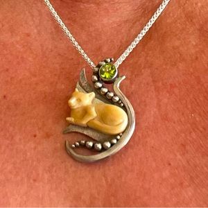 Silver, peridot, carved fossil pendant. Nicely designed 1 1/4 inches long.